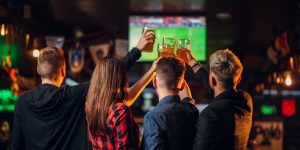 friends watches football on tv in a sport bar P4XERND 1